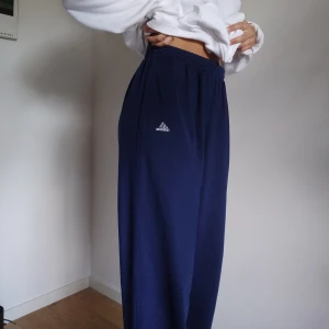 Adidas sweatpants - Mörkblå adidas sweatpants I storlek L, säljer pga för stora, köpta second hand. Har band i midjan och blixtlås vid anklarna. Kan mötas upp i Malmö, annars frakt på 50