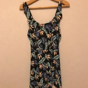 - Söt byxdress med exotiskt tryck från H&M. Knytband i ryggen, vilket blir en söt detalj. Aldrig använd. Storlek 36. Frakt tillkommer!