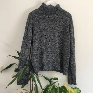 Knitted polo neck - A knitted polo neck jumper, size 22 or could be an oversized jumper to a smaller size. The knit is black and white, giving an overall grey effect.  