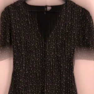 Blommig jumpsuit  - Kort jumpsuit med volang ärmar. 