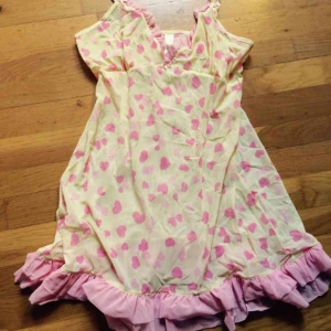  - Världens sötaste citrongula neglige, nattlinne, klänning whatever... med rosa hjärtan och rosa volanger nertill. Den rosa spetsen finns även upptill. Axelbanden går att reglera. Frakt: 42 kr