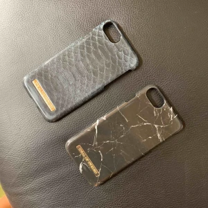  - Mobilskal till iPhone 6s från Ideal of Sweden. 100sek styck. En med reptilmönster i grönblått och ett med svart marmormönster. 