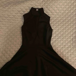  - Svart Klänning från Nelly i skater modell. Halv polo i kragen öppen vid bysten. Använd 1 gång. 