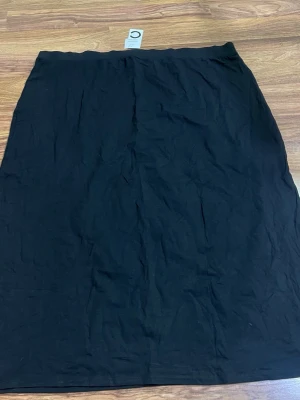 Svart långkjol L Alice Skirt 3XL - En stilren svart långkjol från L Alice Skirt i storlek 3XL. Kjolen har en enkel och rak passform med resår i midjan. Perfekt för dig som gillar minimalistisk stil och vill ha en bekväm kjol i garderoben.