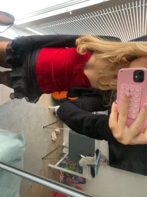 Röd sammetslinnetopp med rosett - Super fin röd topp i sammetsmaterial med en rosett. Toppen är tight och ärmlös, perfekt att styla med kjol eller jeans. Älskar denna topp och har ändast använt en gång så den är väldigt bra skick, säljer pga att den inte kommer till användning❤️ 