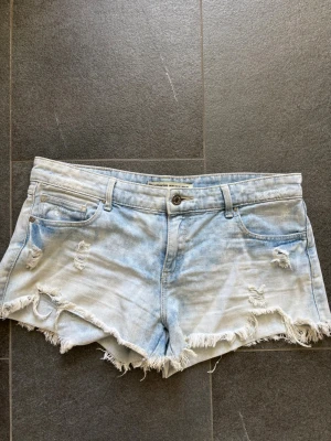 Ljusblå jeansshorts - Säljer ett par ljusblå jeansshorts från Stradivarius. Jättesnygga nu till våren och sommaren