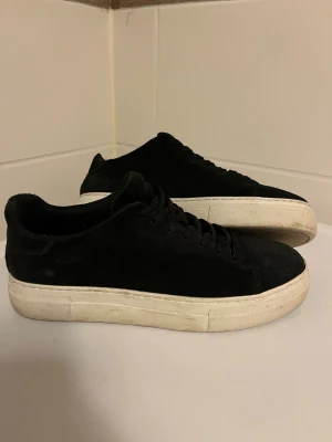 Svarta sneakers med platåsula - Snygga svarta sneakers från selected home. Materialet är i mocka och Perfekta för dig som gillar stilrena och trendiga skor skorna är nästan aldrig använda och är i storlek 41. Ny pris är 1250 men säljs nu för 700 skriv om du har några funderingar.skorna ligger även uppe på Vinted.  Skickas i original kartong dock har lådan lite märken/hack men fungerar som den ska      