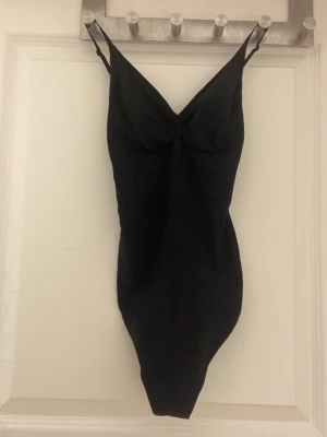 Svart hm body  - Säljer denna sjukt snygga bodyn  för jag tycker inte om axelbanden, aldrig använd och stl S ger jätte fin figur ingen lapp på och den lilla hm lappen har ramlat av men kan lova att den är i s 