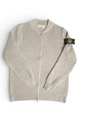 Stone Island zip - Ljusgrå ribbstickad ziptröja från Stone Island med klassisk logopatch på vänster ärm. Tröjan har hög krage, långa ärmar och dragkedja framtill. Perfekt för dig som gillar stilrena och exklusiva plagg. Storlek M men passar S.