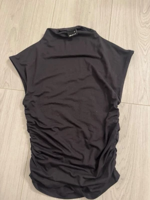 Gina topp  - Gina tricot topp me crunsh på sidan. jätte snygg grå och i bra skick. storlek xs ej använd. inga defekter 