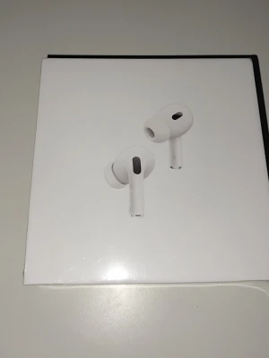 Apple AirPods Pro 2 USB-C - Säljer ett par vita Apple AirPods Pro (2nd generation) med MagSafe-laddningsetui och USB-C. Trådlösa in-ear hörlurar med stilren design och silikonproppar för bra passform. Perfekta för musik, samtal och brusreducering.
