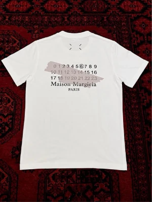 Maison Margiela t-shirt - Vit t-shirt från Maison Margiela perfekt för sommar outfits. | skick : 10/10 har endast använts fåtal gånger så ser ut som ny. | etiketten och påsen följer med på köp! | Storlek EU S | längd : 64 cm | bredd : 46 cm | pris går att diskutera vid bundle köp / snabbaffär! 💯