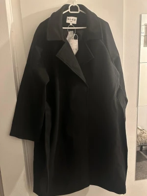  kappa med bälte - Stilren svart kappa med klassisk krage och knytskärp i midjan. Kappan är helt ny med prislapp kvar ✨