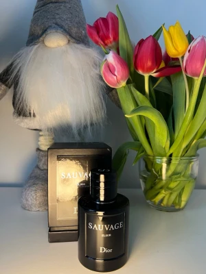 Dior Sauvage Elixir parfym 100 ml - Dior Sauvage Elixir är en exklusiv parfym i en elegant, mörk glasflaska med silverfärgad text. Flaskan har en rund form och matchande svart förpackning. Doften är intensiv och maskulin, perfekt för dig som vill sticka ut med en lyxig signaturdoft.