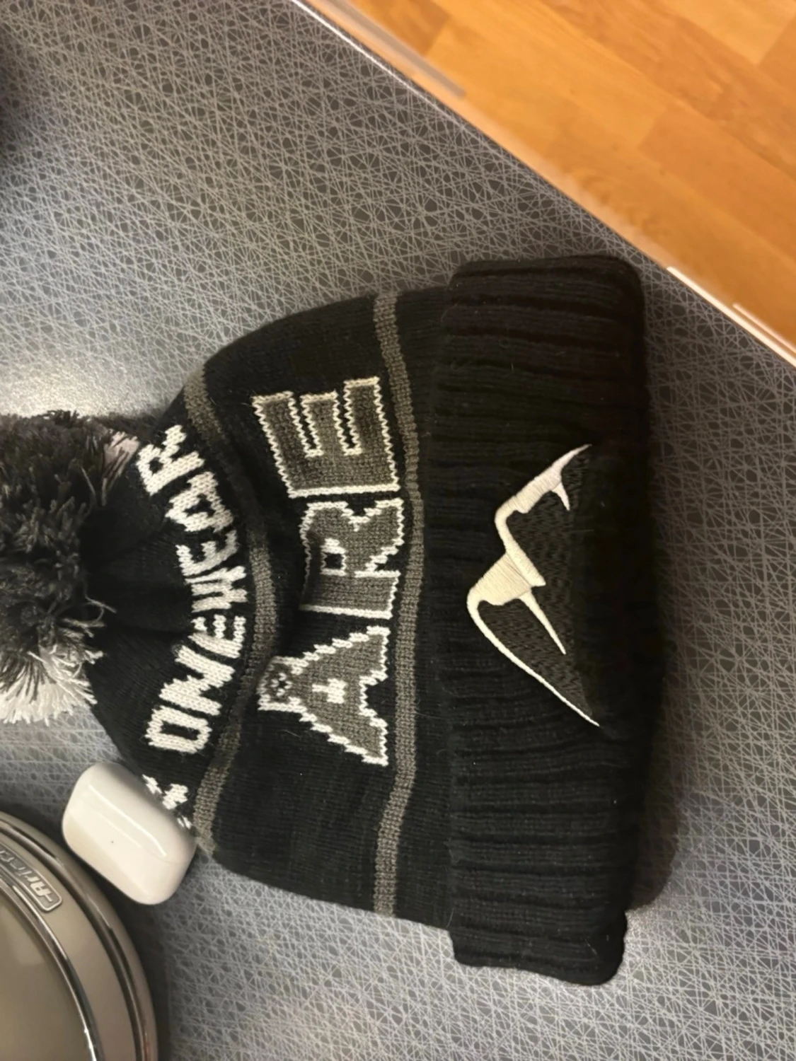 Svart mössa med tofs och Åre-tryck