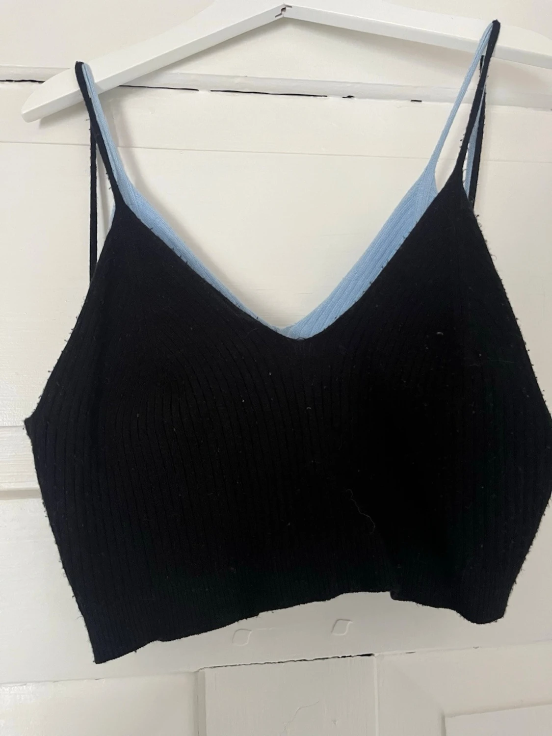 Vändbar ribbad linnetopp svart/blå