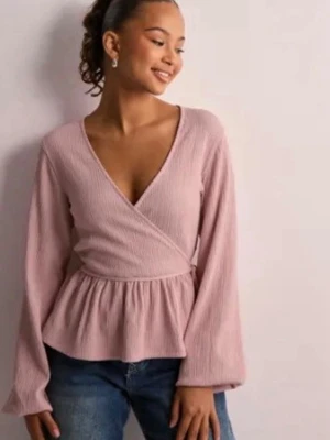 Ljusrosa omlottblus med knyt - Säljer en ljusrosa omlottblus med v-ringning och knyt i midjan. Blusen har långa, luftiga ärmar och ett lätt rynkat peplum nedtill. Från Nelly och knappt använd! I Xs men passar även mig som har S/M