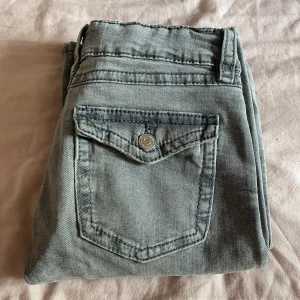 Grå bootcut jeans från Gina Tricot - Snygga grå jeans från Gina Tricot med bootcut-modell och klassisk femficksdesign. Priset kan sänkas till 200kr. Jeansen har låg midja och är perfekta för dig som gillar en avslappnad men trendig look❣️