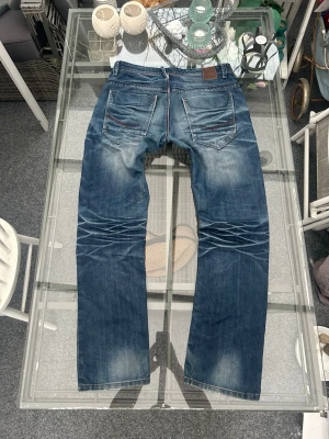  Jacks Denim jeans W32/L32 – loose fit vintage wash - Säljer ett par Jacks Denim jeans i W32/L32. Riktigt clean blå tvätt med snygg fading & whiskers som ger fett bra vintage vibe.  Loose fit så de sitter lite mer avslappnat/baggy – perfekt för streetwear fits eller bara en skön everyday look. Lätt slitna på rätt sätt så de ser bättre ut än nya imo 🔥  Klassisk denim, känns som 100% bomull (ingen stretch), så de håller formen bra.  • Storlek: W32/L32 • Fit: loose fit / baggy • Färg: blå denim • Skick: bra, naturligt slitage • 5-pocket  Perfekta