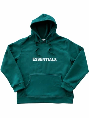 Essentails hoodie - S  - Mörkgrön hoodie från Essentials med snygg text ”ESSENTIALS” storleken är M men sitter mer som S. Hör av er om ni undrar nått! ☺️