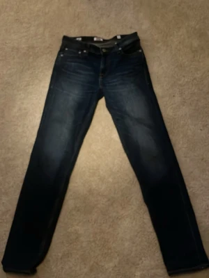 Mörkblå  jeans från Jack and Jones - Ett par snygga jeans från Jack and Jones har knappt använt de nånting. Storlek 164 i barn men passar som 30 i längd och midjan går att justera. Skriv om du har några funderingar.