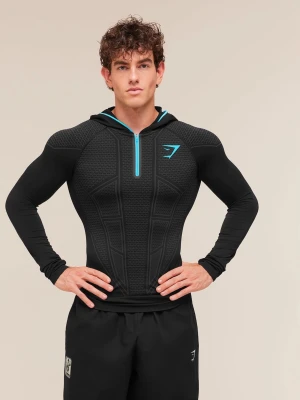 Onyx v1 färg blå  - Slimmad svart hoodie från Gymshark med blå dragkedja och logga. Tröjan har åtsittande passform, mönstrad struktur på bröstet och huva med blå insida. Perfekt för träning och gym med sitt stretchiga funktionsmaterial.