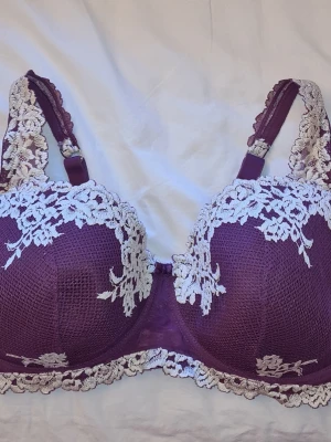 Lila spets-bh från Intimissimi - Snygg lila bh från Intimissimi med vacker vit spetsdetalj över kuporna och axelbanden. Bh:n har justerbara axelband och hakknäppning bak med många hack - därför passar den även mig som har 80C i Bh storlek. Knappt använd alls, så superbra skick!