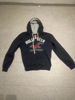Dark blue hollister zip up hoodie - Size L but fits S-M