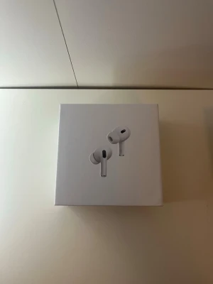 Apple AirPods Pro 2 USB-C - Säljer ett par Apple AirPods Pro (2nd generation) med MagSafe-laddningsetui och USB-C. Hörlurarna är vita, trådlösa in-ear-modeller med stilren och kompakt design. Perfekta för dig som vill ha grymt ljud och smidig anslutning till din iPhone eller andra Apple-enheter. Skriv för mer frågor 