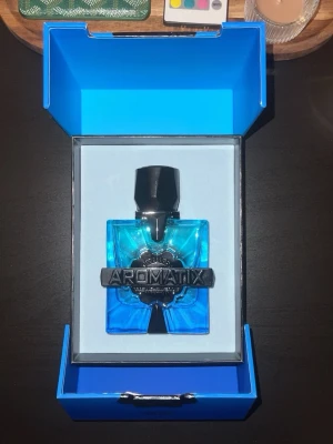 Aromatix Magnetiq Extrait de Parfum - Aromatix Magnetiq Extrait de Parfum kommer i en cool, fyrkantig flaska i klar blått glas med svart kork och en metallisk detalj framtill. Förpackningen är också blå med en stor silverfärgad logga. Perfekt för dig som gillar snygg design och vill sticka ut.