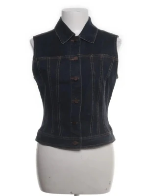 Mörkblå jeansväst med knappar - Snygg mörkblå jeansväst. Helt oanvänd då jag aldrig kunnat hitta rätt tillfälle att ha den eller vetat hur jag ska styla den. 