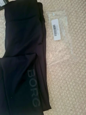 Träningstights - Björn Borg - Snygga svarta träningstights från Björn Borg Performance med diskret logga längs benet.  Jag har aldrig använt byxorna. Tillverkade i stretchigt material som passar perfekt för gym, löpning eller annan träning. Hög midja och bekväm passform. Nypris för denna modell brukar ligga på 499kr
