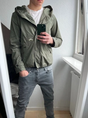 Woolrich windbraker - Ljusgrön vindjacka från Woolrich med huva och dragkedja. Rikigt skönt nu till våren och de varmare tiderna☀️ inga defekter hör av er om ni är intresserade eller har något fråga☺️