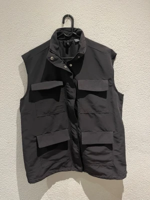 Svart utility-väst med stora fickor - Säljer min svarta väst då den är för stor för mig och aldrig använts 🩶