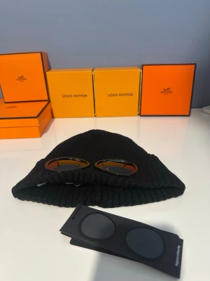 Svart cp company mössa - Säljer en helt ny svart mössa från CP Company. Aldrig använd – i perfekt skick med tags kvar.  Stilren design med de ikoniska goggles-detaljerna framtill som ger en unik look. Passar både till vardag och streetwear-outfits.  Pris: (kan diskuteras vid snabb affär)  Hör av dig vid intresse eller frågor! Går att byta!