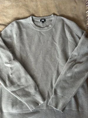 Stickad tröja - Helt oanvänd stickad tröja från Uniqlo. Köptes för 599 kr men har aldrig kommit till användning för att den är för kort för mig. Tröjan har ett skönt material med bra kvalitet.