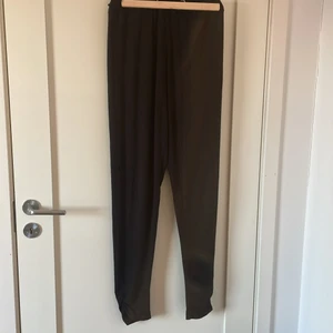 Svarta byxor från pomp de lux - Svarta luftiga byxor från pomp de lux med insömnad på anklarna! Byxorna är i storlek 170! Köpta för 300kr ish. Jag säljer dom 84+66kr spårbarfrakt! Byxorna är inte så använda och är i väldigt bra skick! Perfekta byxor för våren och sommaren eftersom dom har ett luftigare material! 