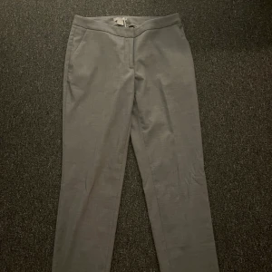 Lågmidjade kostymbyxor - Grå lågmidjade kostymbyxor fråm HM i storlek 36. Kommer inte till användning. Bra längd på mig som är 164 cm.