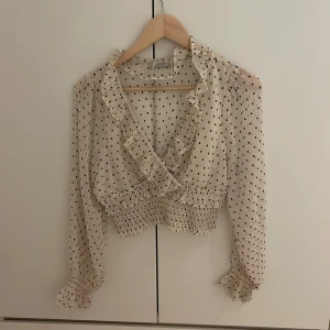 Prickig blus - Prickig blus från bikbok. Den har volanger och v-urringning. Snygg och lätt💗