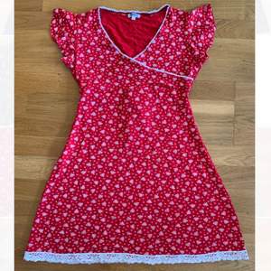 Röd, blommig klänning från Savann. Storlek M, men är elastisk. 