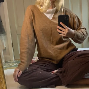 Stickad brun tröja från H&M - Brun V-ringad stickad tröja från H&M. Mycket mjukt och bekvämt tyg. I princip oanvänd, använd vid max 3 tillfällen. Fin att ha med något under men även utan. Storlek S