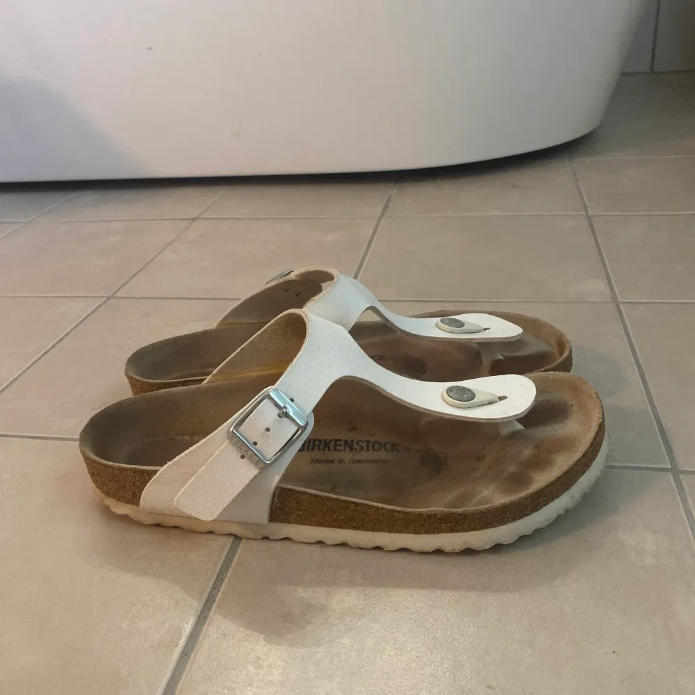 Vita birkenstock i modellen Gizeh. Storlek: 37. Använt skick men inga större ytliga skador. Frakt tillkommer (PostNord spårbar). Skor.