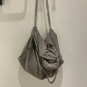 Stella McCartney väska - Säljer denna grå/gröna stella väska 🙌🏼❤️‍🔥💕 så snygg (!!!), är i använt, men absolut bra, skick! hör av er vid frågor, prisfundering eller fler bilder 💖