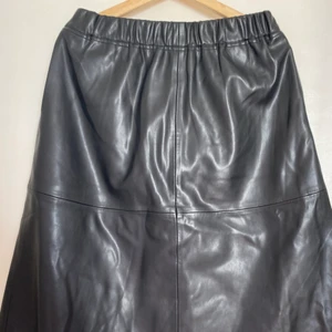 Carin Wester a-line skirt - Carin Wester Leather imitation a-line skirt. Elastic waist. Pockets on both sides. Excellent condition. Midi length. 