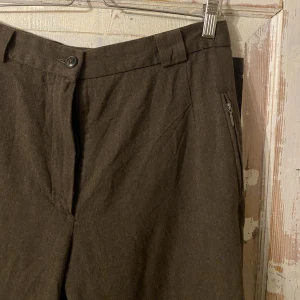 Kostymbyxor  - Bruna kostymbyxor jag köpt secondhand. Jag har använt dem som lågmidjade. Har vanligtvis strl 36 eller 27 i byxor och dessa satt på höften, under naveln, på mig. Så det beror på hur man vill att dem ska sitta. 