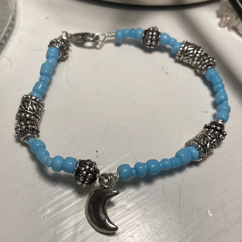 Egengjort armband i blått och silver med en berlock som föreställer en måne💓 kolla min profil för mer smycken! Köparen står för frakt och använd gärna köp nu💓. Accessoarer.