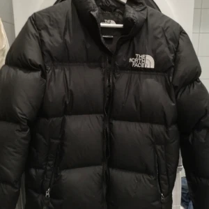 The North Face Jacka - Säljer min The North Face jacka som är köpt förra året. Den har ett litet hål där bak som inte syns så extremt mkt.  Den är köpt i Junior storlek XL men sitter som en i vanlig. Överlag så är den i bra skick, varm och snygg till vintern! fler bilder i dm💛