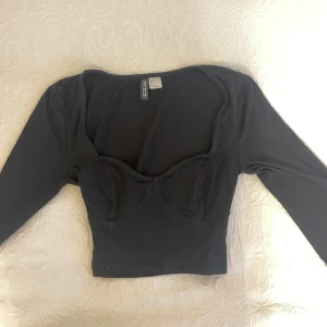 Svart långärmad croptop  - En svart kort croptop från hm som formar sig superfint. I bra skick men kommer inte till användning 🖤