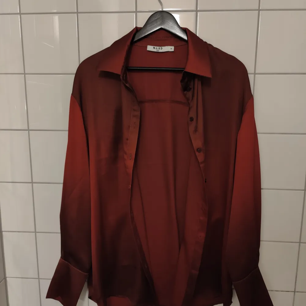 Röd/vinröd satinskjorta från NA-KD. Jag brukar ha s-m, sitter oversize på mig . Skjortor.