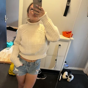 Vit stickad polotröja, croppad - Säljer en chunky, croppad polotröja i vit stickad kvalitet. Tröjan har lång ärm, hög krage och en loose fit som ger en chill vibe. Perfekt att styla med jeans eller kjol för en trendig look. Storlek XS köpt ifrån hm. Jätte fin tills höst/vinter🥰
